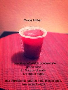 a red drink sitting on top of a table next to a measuring cup filled with liquid