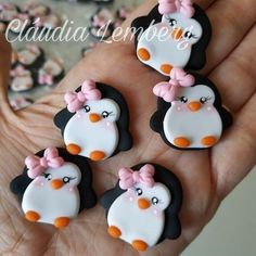 there are four decorated penguins in the palm