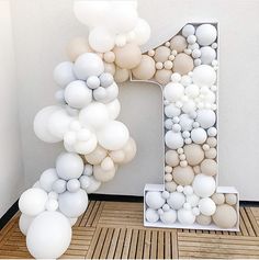 the letter f is made out of balloons and placed in front of a white wall