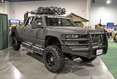 a gray truck parked on top of a cement floor