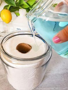 a person is pouring water into a jar filled with toilet paper next to lemons