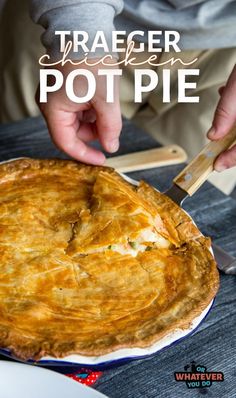 a person cutting into a pie on top of a table