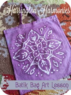 a purple bag sitting on top of a rug