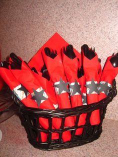 a basket filled with red and black napkins