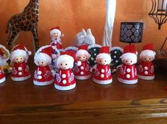 a group of small figurines sitting on top of a wooden table