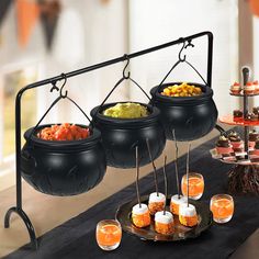 an assortment of food is displayed on a buffet table with oranges and cupcakes