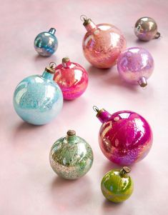 there are many different colored ornaments on the table