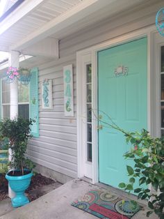 an overhead view of a porch with potted plants on the side and blue shutters