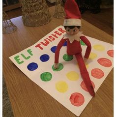 an elf is sitting on top of a paper towel with circles and dots around it