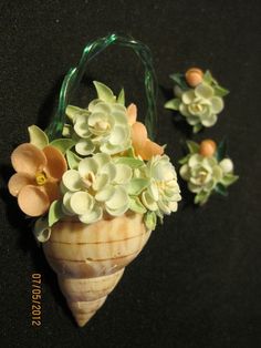 a vase filled with flowers sitting on top of a black table next to other items