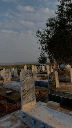 an old cemetery with headstones and trees in the background