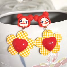 Unique Clown Earrings With Yellow Checkered Flowers And Red Hearts. New Boutique. 2.25" Long Metal Content Unknown. Circuscore Aesthetic, Clowncore Accessories, Clown Jewelry, Clown Flower, Clown Earrings, Toothpaste Kisses, Bird Eyes, Eenie Meenie, Clown Pics