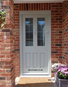 a white front door on a brick house