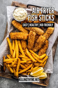 air fryer fish sticks with lemon wedges and ketchup on the side