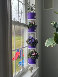 a window sill filled with potted plants next to a window