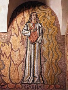 the mosaic on the side of a building depicts a man holding a basket with food in it