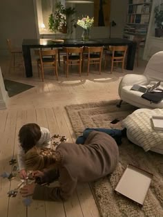 a child playing with puzzle pieces on the floor