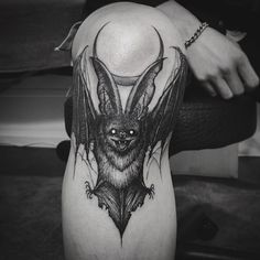 a black and white photo of a bat on the thigh