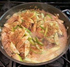 a pan filled with food sitting on top of a stove