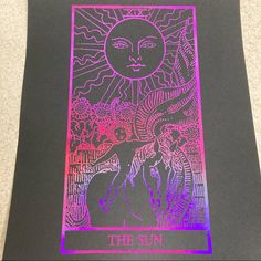 the sun tarot card is lit up in pink and purple