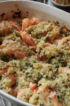 a casserole dish with shrimp and herbs in it