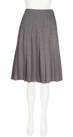 This early-1970s Valentino Boutique pleated knee-length skirt was made in Italy of unlined gray wool that fastens up the left side with a metal zipper. It's in excellent condition, professionally dry-cleaned and ready to wear. Measurements: Waist - 28" (pinned on the mannequin) Hips - 38" Length - 24" Label Size: 14 (fits like a S/M) IMPORTANT NOTE FOR CANADIAN SHOPPERS: There is a 15% shipping fee that is automatically applied to Canadian orders, as legally we need to charge and remit sales tax domestically. We will promptly refund any overcharge, and apologize for any inconvenience. Pleated Skirt Knee Length, Formal Gray Pleated Skirt, Classic Knee-length Wool Bottoms, Gray Knee-length Formal Skirt, Formal Gray Knee-length Skirt, Formal Knee-length Gray Skirt, Classic Knee-length Pleated Skirt For Winter, Pleated Wool Skirt For Fall, Spring Wool Pleated Skirt