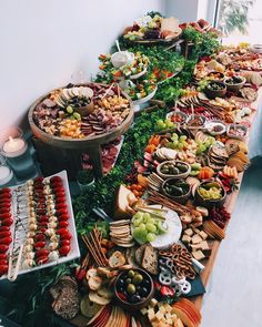 a long table filled with lots of different types of food on it's sides