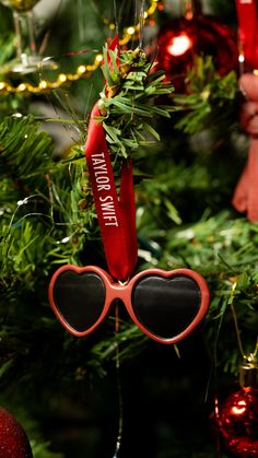 a pair of heart shaped sunglasses hanging from a christmas tree