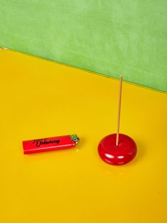 a small red object sitting on top of a yellow table