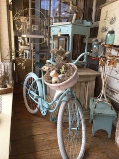 an old bicycle with a basket full of plants