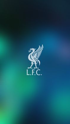 the liverpool football club logo is shown on a blurry blue and green wallpaper