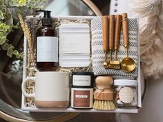 an assortment of items in a white box with gold spoons and other kitchen utensils