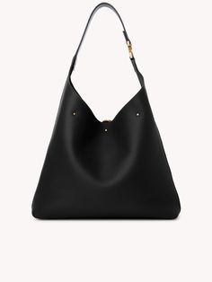 Chloés' Marcie Hobo shoulder bag in Black. This bag features a grained texture, single flat top handle, suede lining, internal zip-fastening pocket, gold-tone hardware, open top, and tassel detail. PRODUCT DETAILS: Color: Black Material: Outer: Calf Leather 100% Lining: Calf Leather 100% Designer ID: HC24SS630I31207 *Product Measurements Width: 14.2" (36 cm) - Height: 11.4" (29 cm)- Depth: 3.9" (10 cm)- Handle drop: 11" (28 cm) Modern Shoulder Bag With Gold-tone Hardware For Shopping, Formal Hobo Shoulder Bag With Gold-tone Hardware, Evening Hobo Bag With Metal Hardware, Formal Shoulder Hobo Bag With Gold-tone Hardware, Classic Hobo Shoulder Bag With Gold-tone Hardware, Luxury Hobo Bag With Gold-tone Hardware And Double Handle, Luxury Hobo Bag With Gold-tone Hardware For Daily Use, Classic Hobo Bag With Double Handle And Metal Hardware, Top Handle Hobo Bag With Gold-tone Hardware