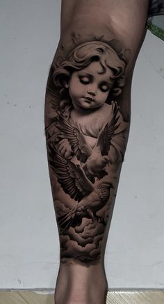 a tattoo on the leg of a person with an angel and dove in their hands