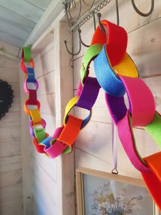 there is a multicolored ribbon hanging from the hooks on the wall in this room