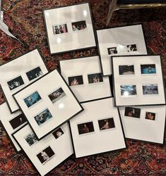 a pile of white frames sitting on top of a rug