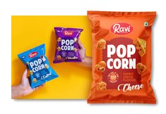 two bags of pop corn next to one bag of cheetos on a yellow background