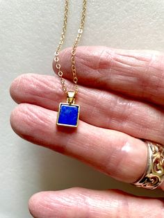 Rich blue lapis lazuli gemstone set in 24k gold fill bezel on delicate 14k gold fill necklace.  Beautiful trendy rectangular lapis lazuli pendant is 17.7 x 9.7mm in rich blue color with tiny flecks of golden pyrite. Completely natural gemstone.  Lapis lazuli pendant hangs from delicate 14k gold fill flat cable chain with spring ring clasp. Lapis Lazuli Pendant, Lapis Lazuli Necklace, September Birthstone, Unique Earrings, Spring Rings, Lapis Lazuli, Gold Filled, Natural Gemstones, Necklace Lengths