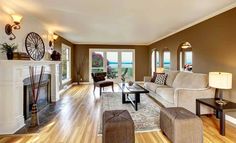 a living room filled with furniture and a fire place in the middle of a room