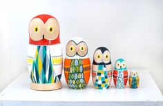 an assortment of colorfully painted wooden owls