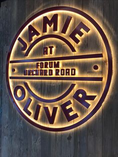 a sign that says damf at the front of a building with lights on it