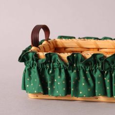 a basket with green fabric and gold stars on it