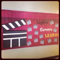 a bulletin board with some movie claps on it and words that read lights camera learn