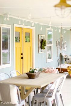 a table and chairs in a room with yellow doors