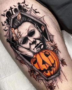 a man's leg with a skull and pumpkin on it