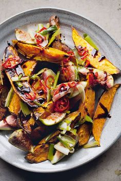 a white plate topped with sliced up vegetables