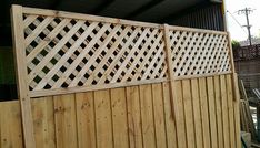 a wooden fence that is next to a building