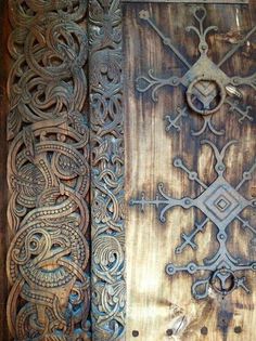 two wooden doors with intricate designs on them