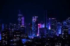 the city is lit up at night with bright lights on it's skyscrapers