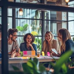 group of people sitting around a table in a restaurant smiling at each other and laughing